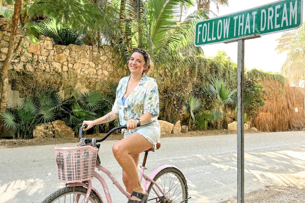 A girl sitting on a bike in Tulum