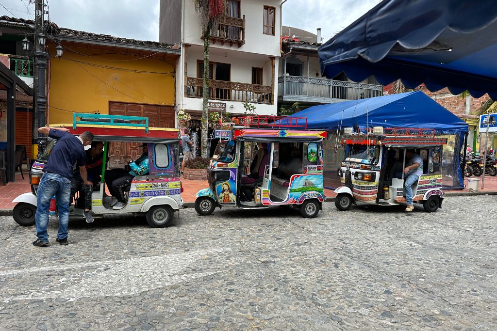 tuk-tuks parked on the main square of guatape