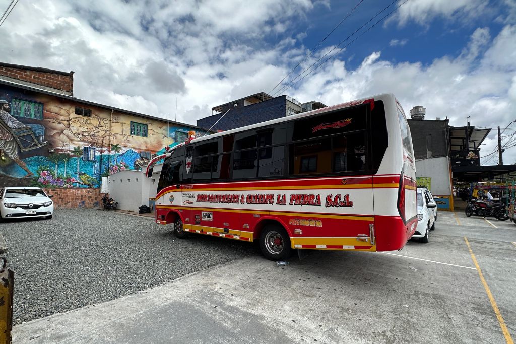 one of the buses that take you from medellin to guatape parket at guatape bus station