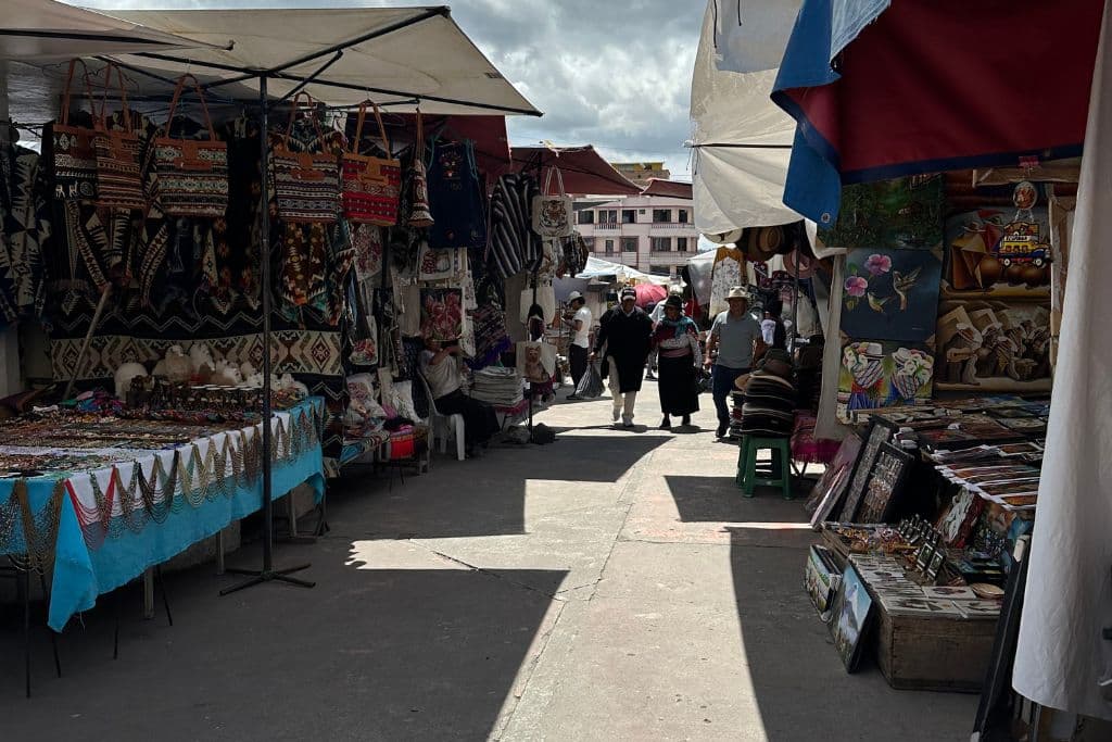 A view of multiple handicraft market stalls in Otavalo