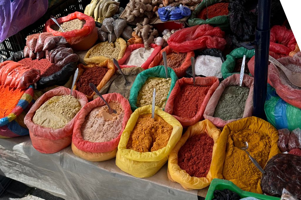 Multiple colourful spices on display in the Otavalo Market