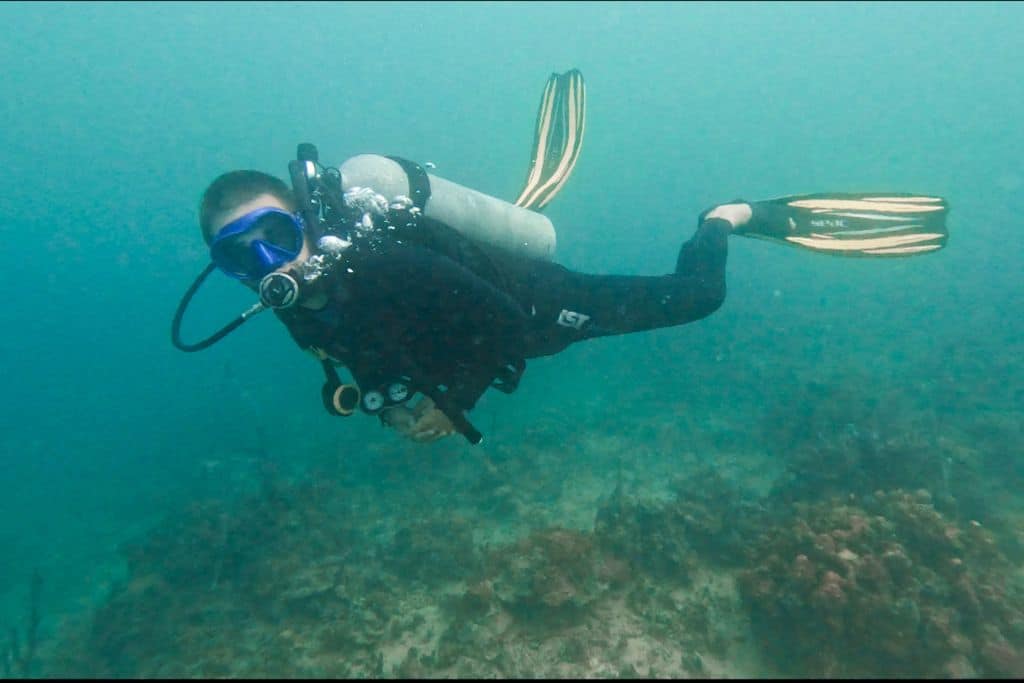 Diver in the ocean in Panama, with nothing but open blue water behind him