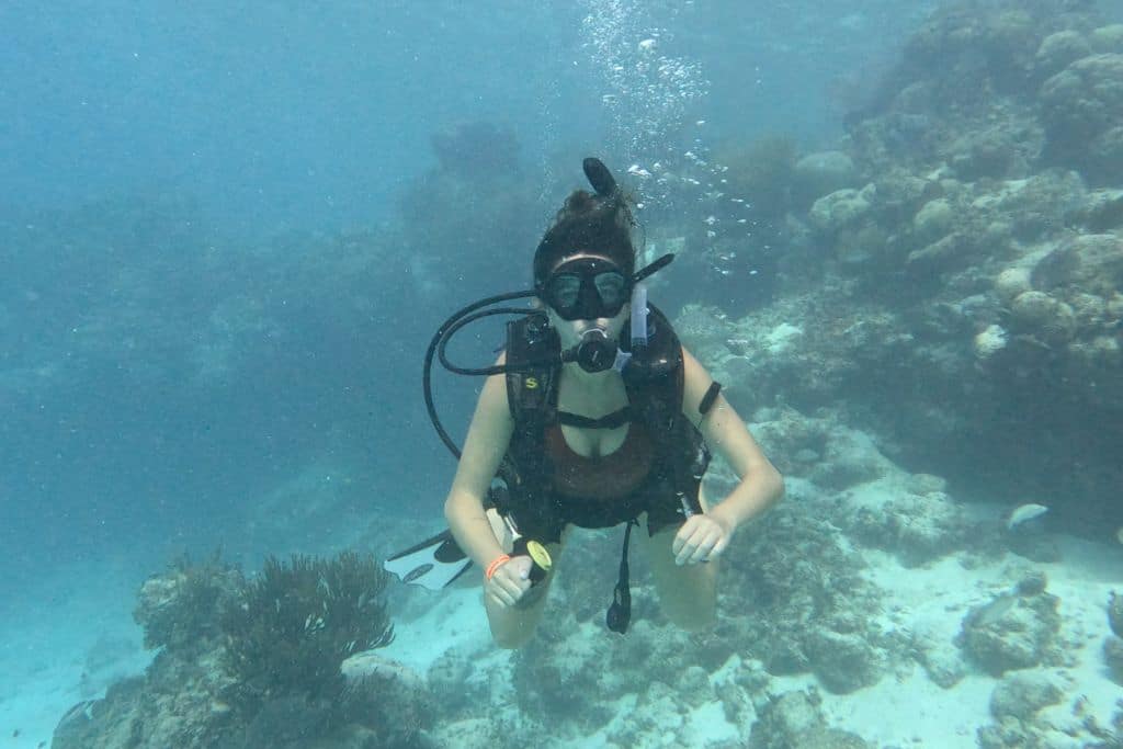 A girl scuba diving in the sea in Belize