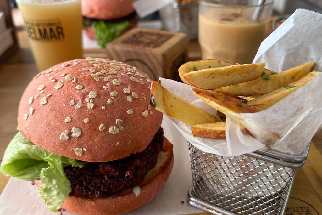 A pink vegan burger and fries