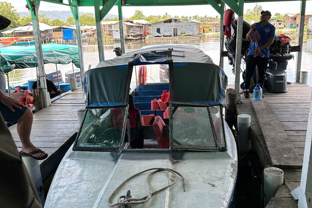 An old speed boat parked at a dock in Panama