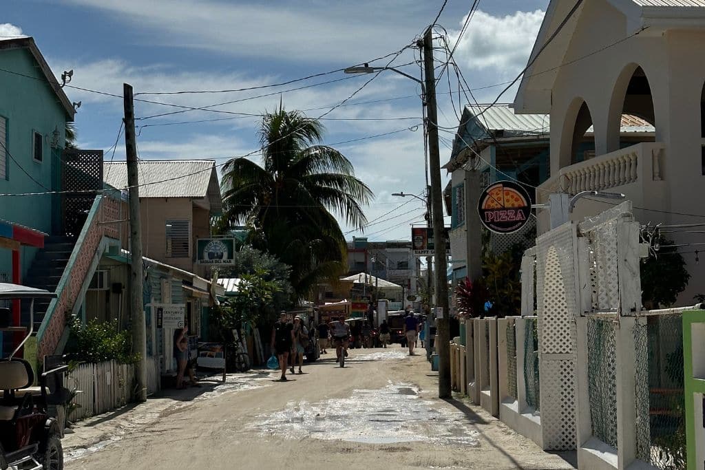 the main street on Cay Caulker in Belize is a dirt road with no cars